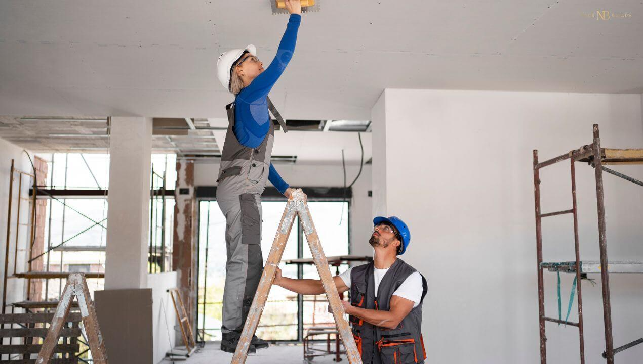 workers are plastering a new build.