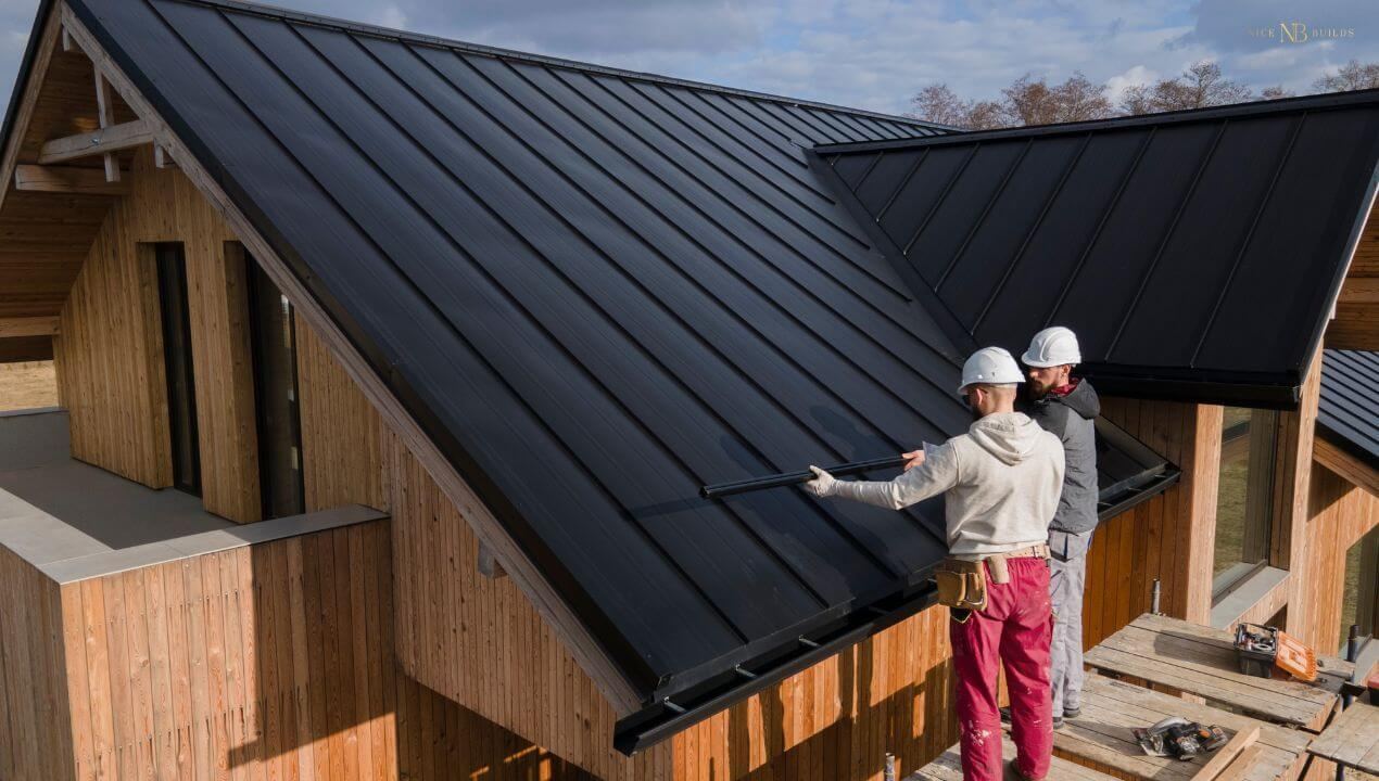 Construction workers are working on the ceiling of a home.