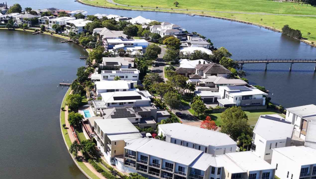 an aerial view of homes and townhouse residences along a canal 